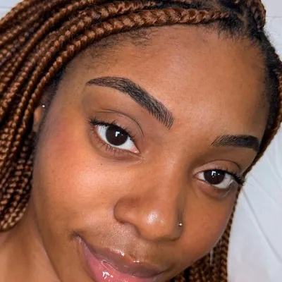 A client’s microblading treatment, showing fine brow hairstrokes
